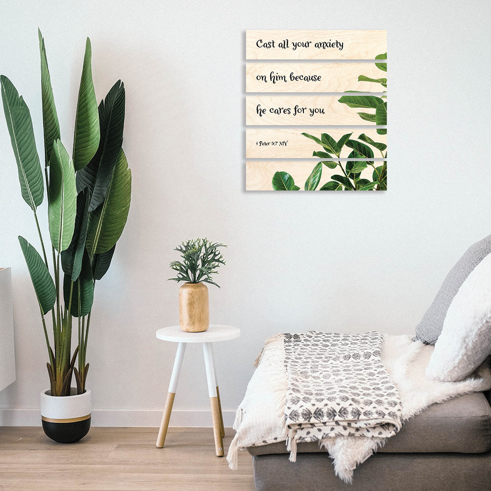 Mockup of a multi panel wood poster with leaves on it.