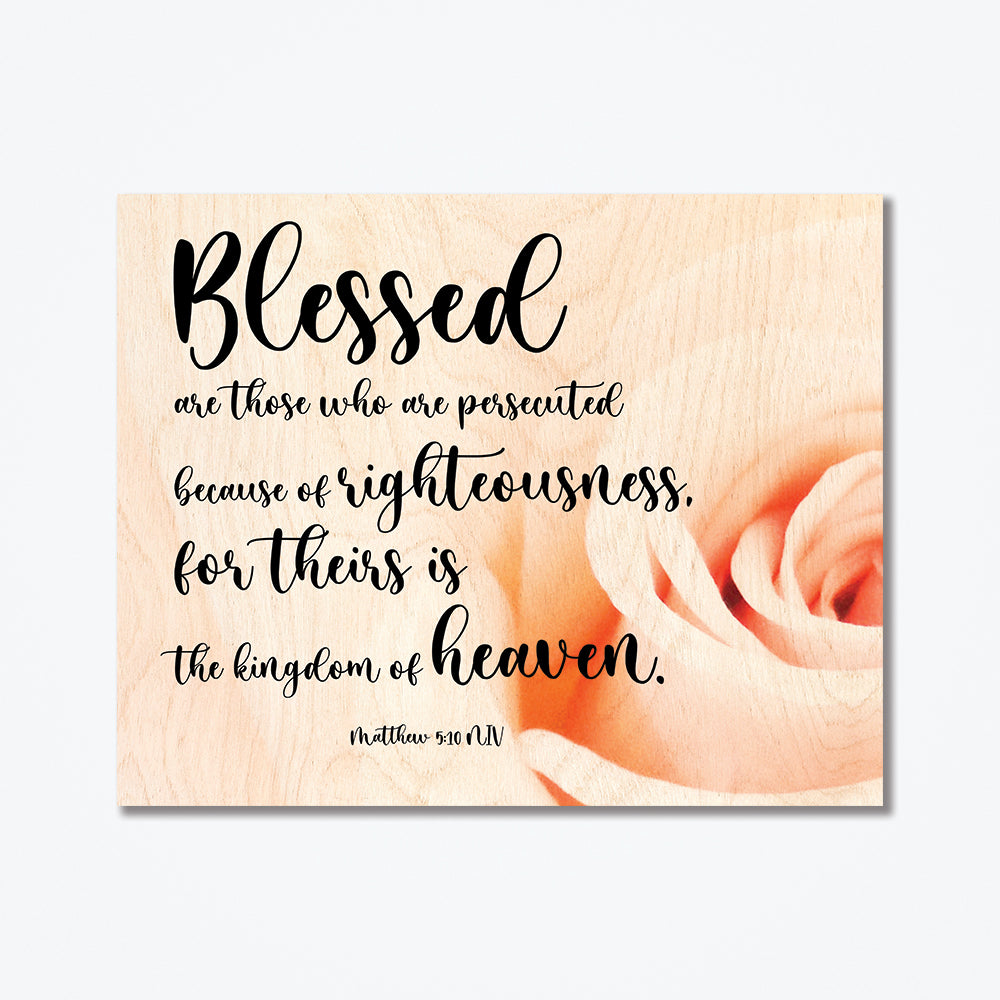 A wood poster of a rose and cursive black text.