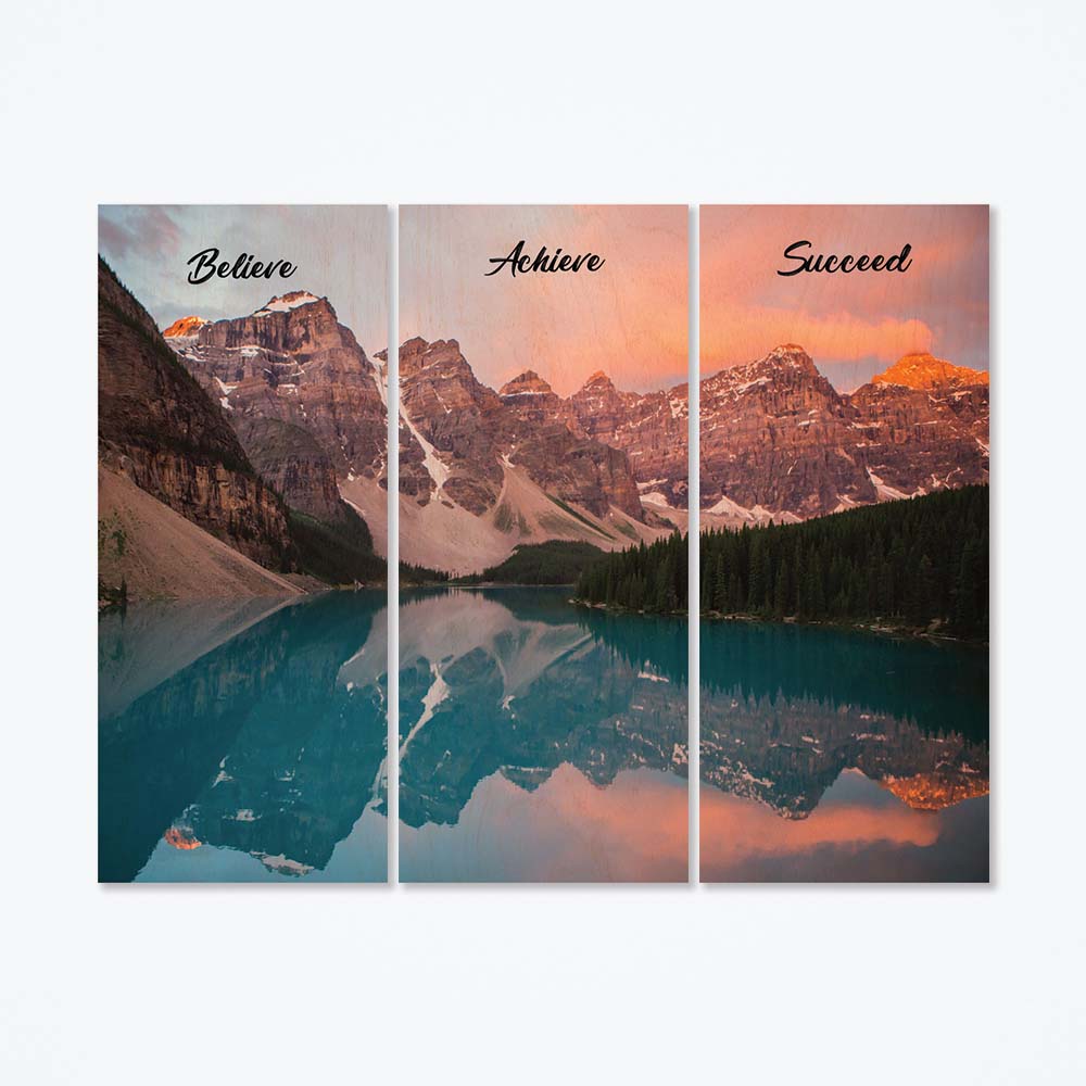 Three wood posters with a design of a mountain that carries over to each panel.