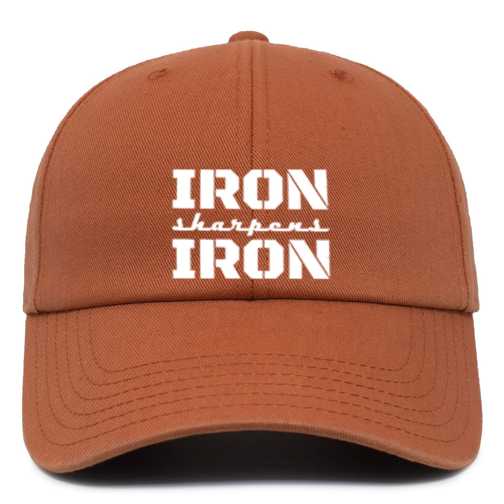 Rust colored tucker hat with white text on the front.