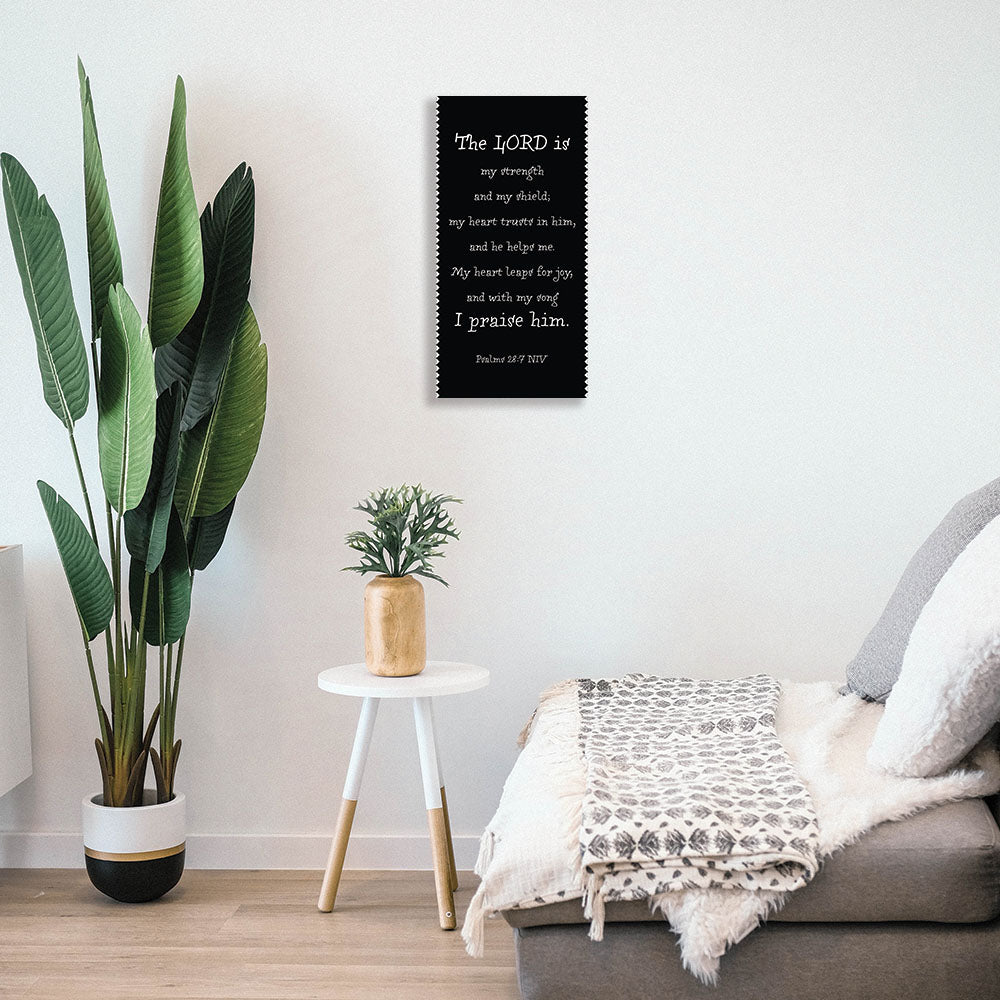 A metal poster with a black background and white text mocked up to show how it will look in your home.