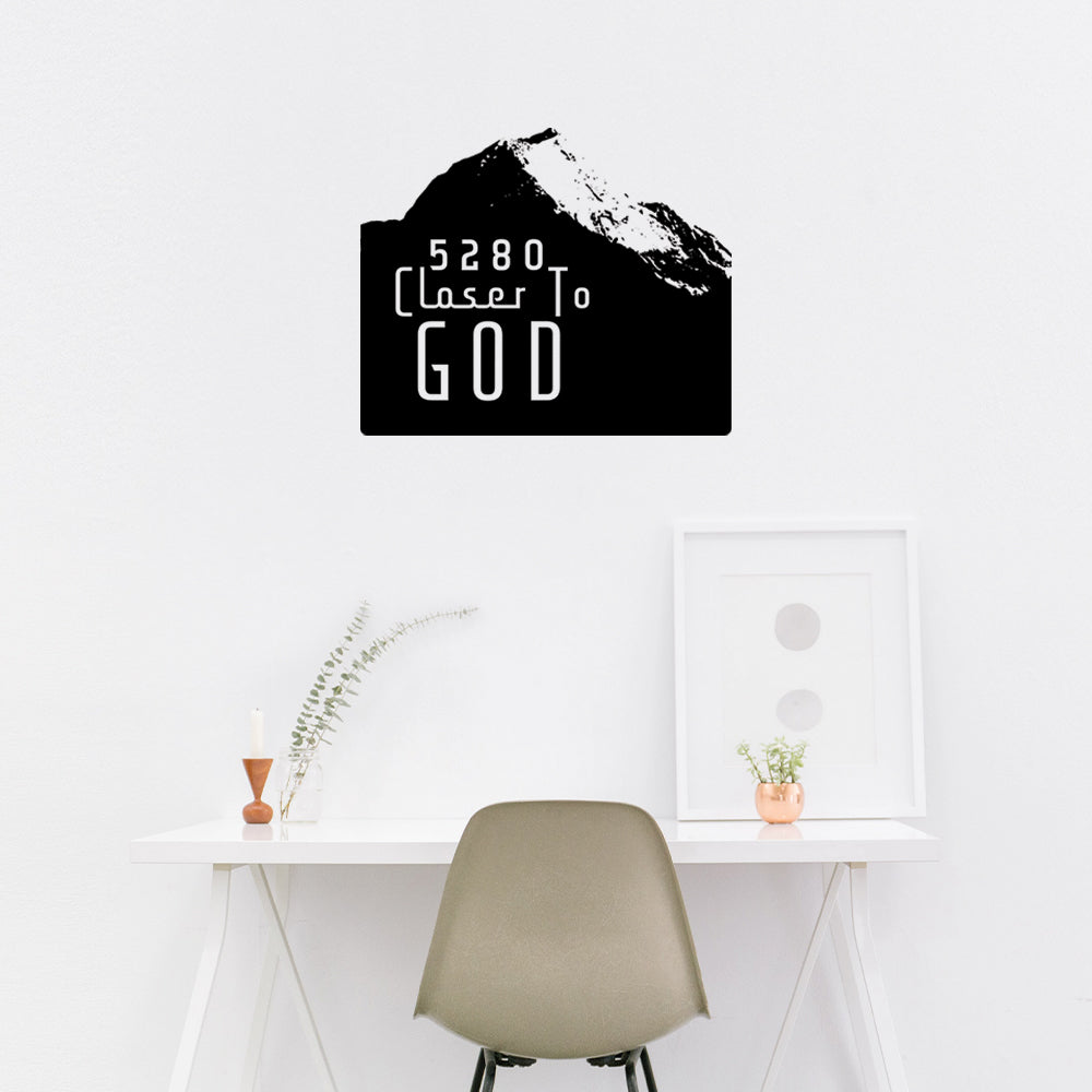 Mockup of the wall sticker with black mountains and white text in your home.